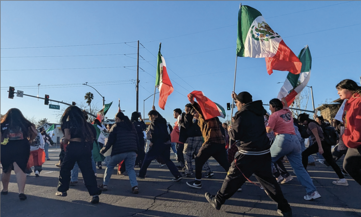 Students from William C. Overfelt High School march on King Road along with other protesters from the community to protest against ICE. 